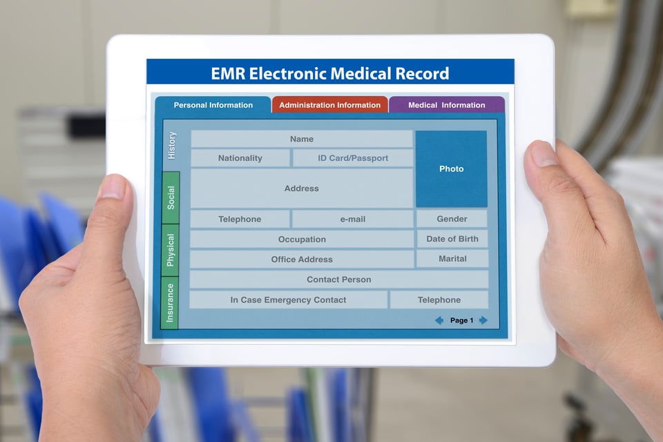 Electronic medical record application showing blank patient information on digital tablet screen in someone hands.